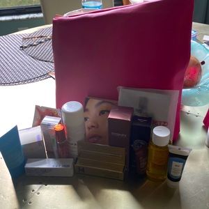 Pink cosmetic bag with lots of cosmetics